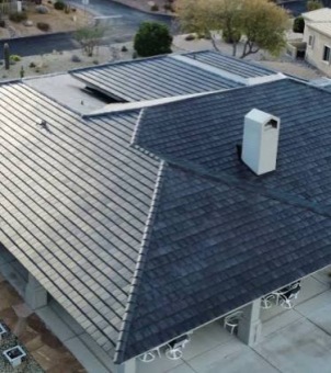Aerial view of commercial building and carport roofs covered with GreenMore integrated solar tiles